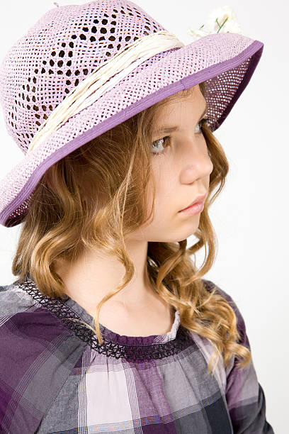 Pensive girl in a hat stock photo