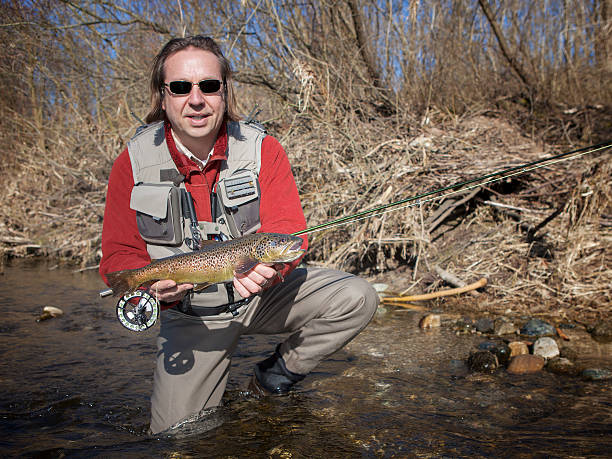 istock Flyfisherman holding a brown trout 175902529