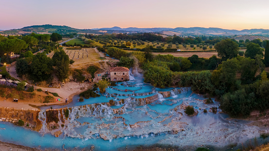 Toscane Italy, natural spa with waterfalls and hot springs at Saturnia thermal Baths, Grosseto, Tuscany, Italy aerial view on the Natural thermal waterfalls couple on vacation holiday inSaturnia Tuscany