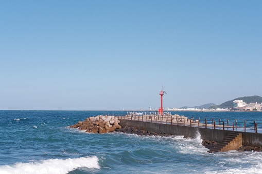 A majestic, iconic lighthouse on the coast of Jeju Island, South Korea