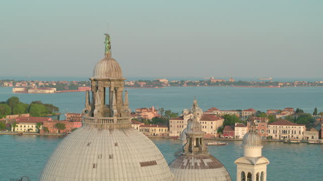 Aerial view of the dome of the Basilica di Santa Maria della Salute in Venice, Italy in sunshine. 4K