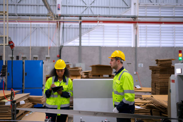 istock Blue collar worker and cardboard package factory. 1759094931