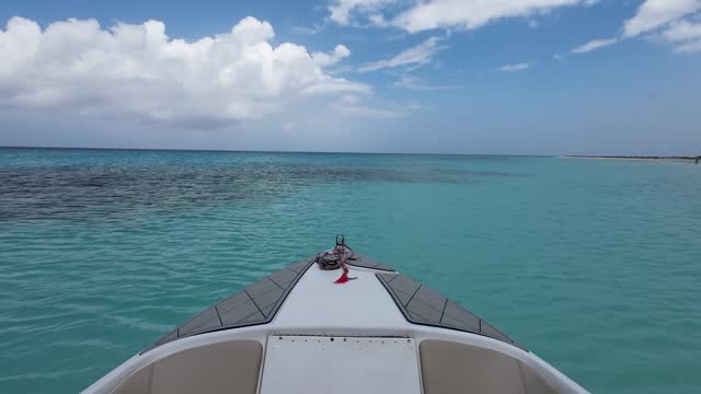 Watch sea from inside luxury boat floating on blue caribbean sea, tilt up