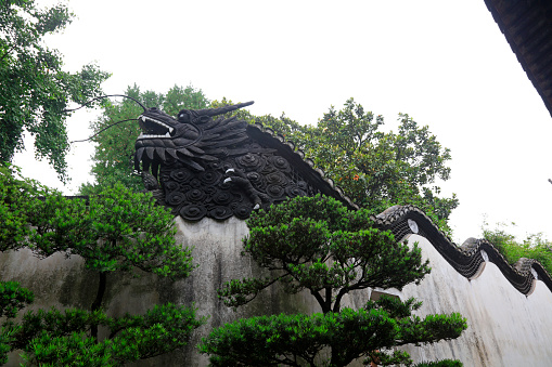 Shanghai, China - May 31, 2018: The sculpture of the dragon head is on the wall in Yu Garden, Shanghai, China