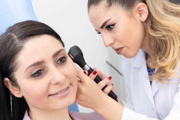istock Female doctor doing female ear check in her office. 1759114947