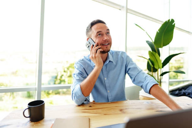 istock Handsome businessman speaking on the phone in office 1759131681