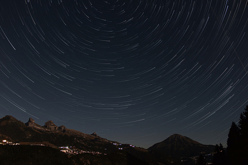 alpine nocturnal landscape with star trails