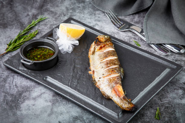 istock River trout baked in josper with sauce and lemon on a dark background 1759162401