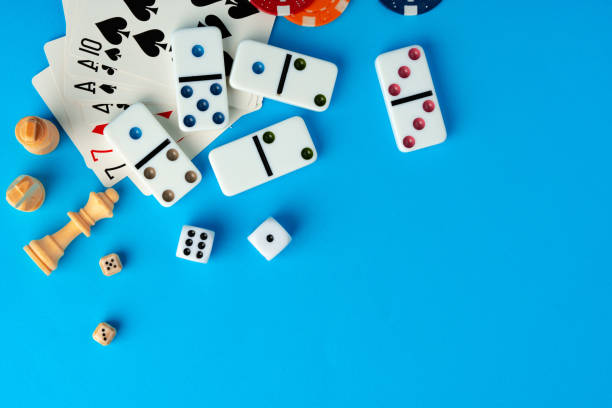 istock Items for playing chess, poker and domino on blue background studio shot 1759168916