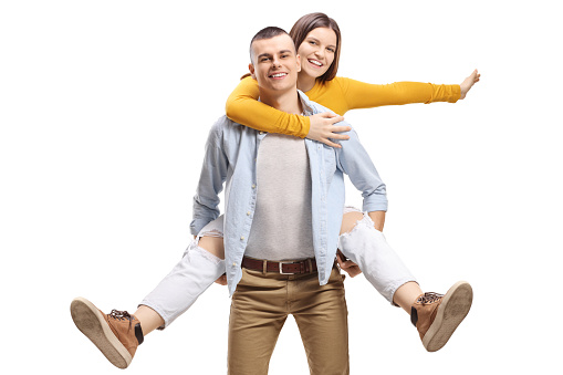 Guy carrying a happy young woman on his back isolated on white background