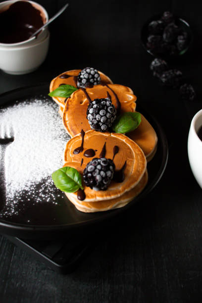 istock Pancakes with berries on a black wooden background. dessert. breakfast. 1759176364