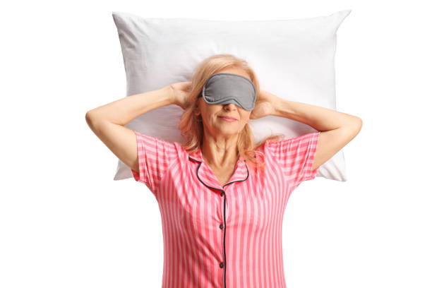 istock Woman in pajamas with a mask sleeping on a pillow 1759183462