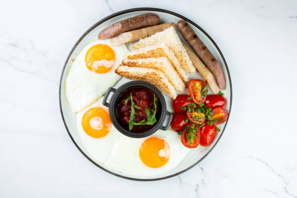 istock English breakfast with grilled sausages, scrambled eggs, cherry tomatoes and toast 1759203217