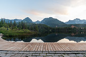 Strbske pleso lake with peaks on the background in High Tatras mountains in Slovakia during early morning before sunrise
