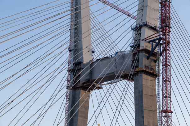 istock Crane and bridge construction against a blue sky background. 1759207691