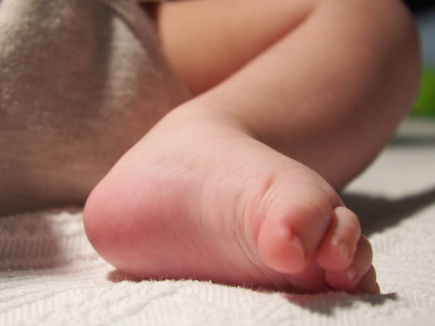istock Cute baby's feet on the bed 1759235060