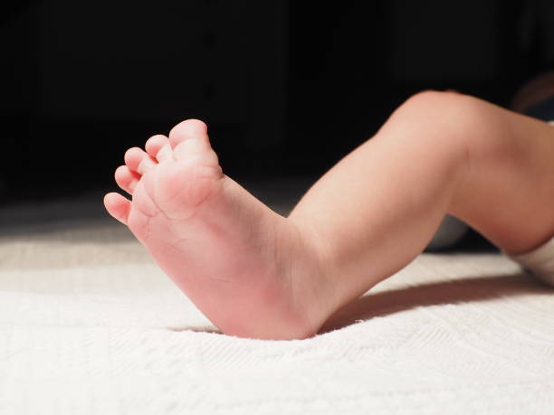 istock Cute baby's feet on the bed 1759235664