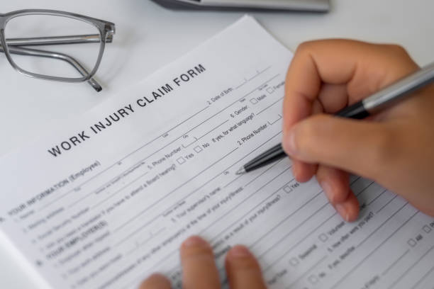 Woman filling Work Injury Claim Form