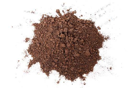 Top view of a small mound of soil isolated on white background