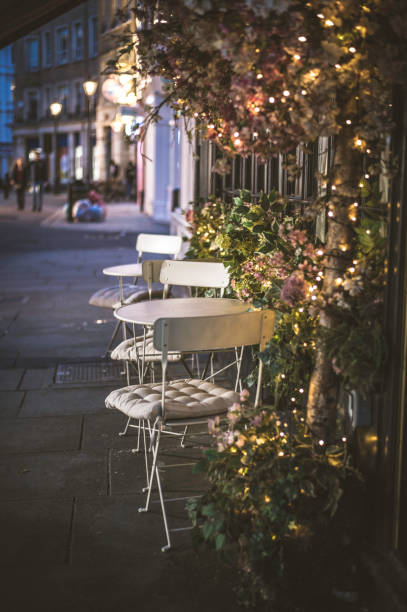 Bistro tables, lining the pavement of a city