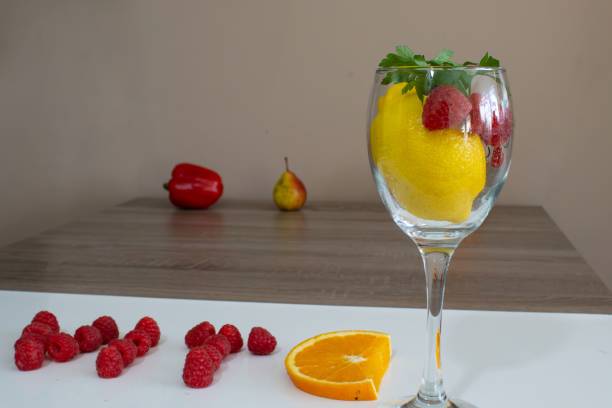 istock Fresh lemons and raspberries placed in a clear glass 1759289773