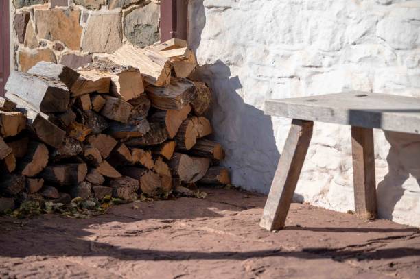 istock Firewood cut and stacked neatly on colonial rustic front flag stone  porch 1759299731