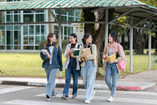 Group of Young Asian student walking and talking at university before class room. education, back to school concept