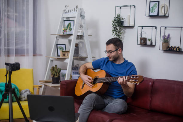 istock Man playing guitar on living room sofa 1759306775