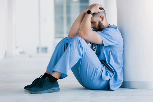 Doctor, stress and sad on floor for hospital mistake, healthcare fail or bad news of clinic death. Mental health of medical worker, tired man or nurse with headache, depression and anxiety or fatigue