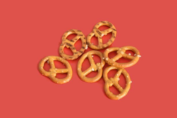istock Salty pretzel for beer on a red background 1759312994