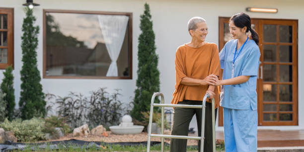 istock Nurse or caregiver help elderly walk by using walker in garden 1759313611