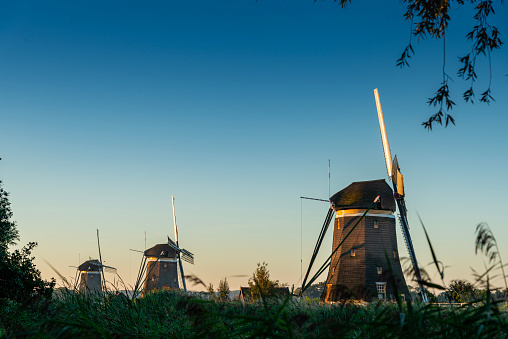 Traditional windmill in beautiful scenery with blue sky and clouds on a sunny day in summer
