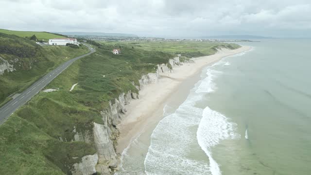 Causeway Coastal Route On Limestone Cliffs Of Northern Ireland Near Portrush. aerial