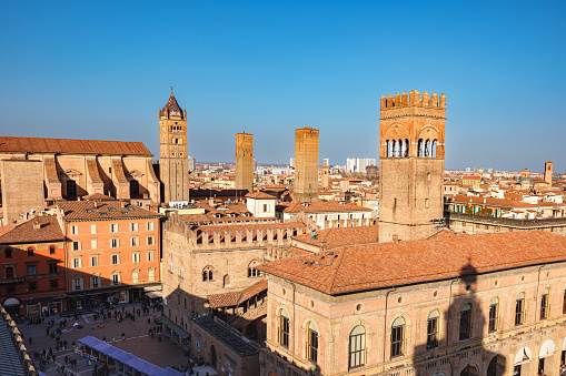 Bologna, Italy - March 5, 2023: Aerial view on historical buildings rooftops and towers on Piazza Maggiore - square in center of Bologna, Italy