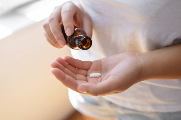 istock Young woman with pills in her hands 1759377641