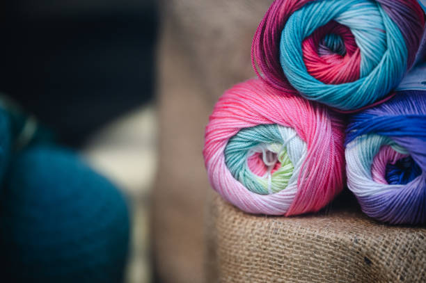 Close-up of colorful yarn balls with a crochet needle, ready for a knitting or crocheting project