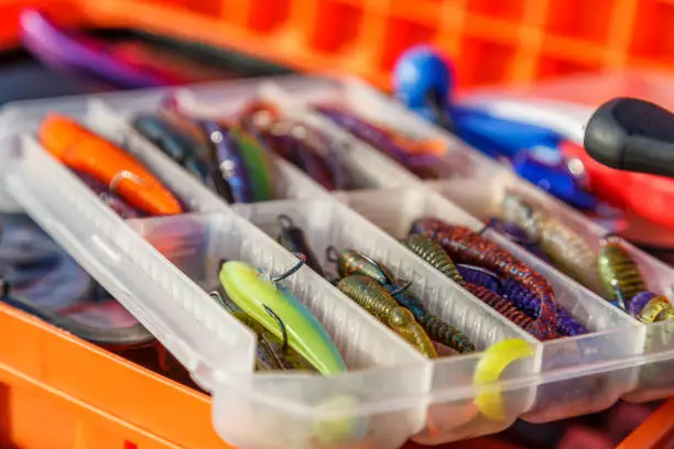 Photo of A large fisherman's tackle box fully stocked with lures and gear for fishing.fishing lures and accessories.Fishing tackle - fishing spinning. Kit of fishing lures.