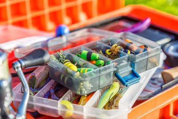 Photo of A large fisherman's tackle box fully stocked with lures and gear for fishing.fishing lures and accessories.Fishing tackle - fishing spinning. Kit of fishing lures.
