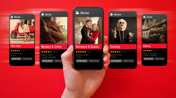 Person browsing movies online on mobile phone and viewing cinema ratings and reviews Person browsing movies online on mobile phone and viewing cinema ratings and reviews divergent movie review stock pictures, royalty-free photos & images