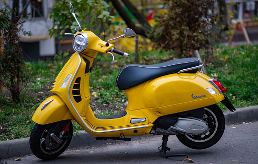 October 23, 2022. Moscow, Russia. A yellow Vespa scooter in the courtyard of a residential building in the center of the Russian capital.