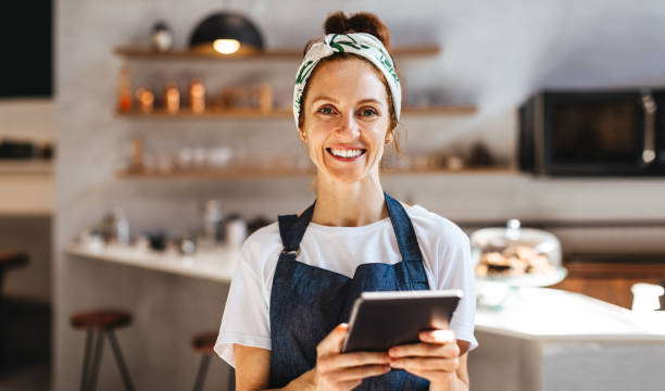istock Successful cafe owner using a tablet to manage her small business 1759406493