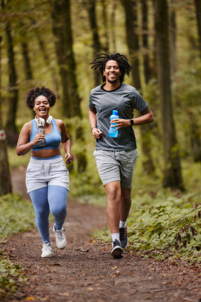istock Happy black athletic couple jogging in the forest. 1759426707