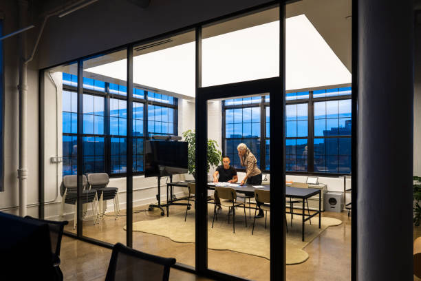 istock Colleagues organizing paperwork in meeting room 1759433517