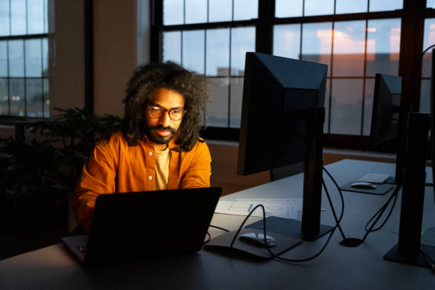 istock Focused business professional working late alone in dark office 1759433550