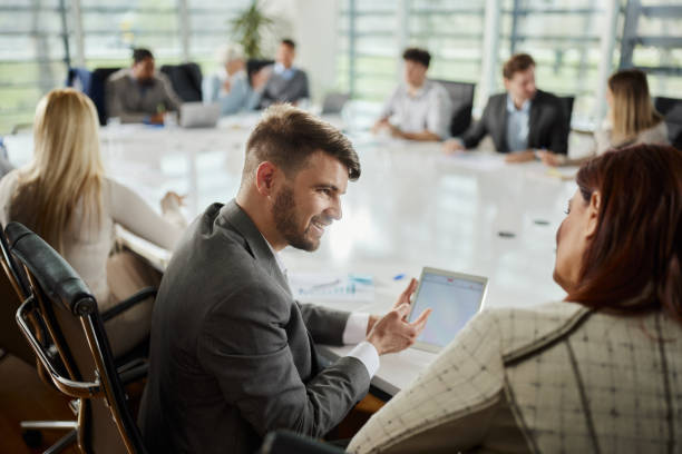 istock Happy businessman using touchpad with his colleague on a meeting. 1759441301