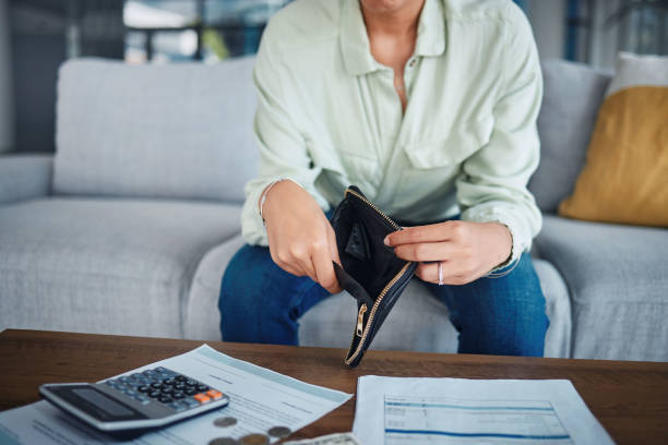 istock Empty wallet, money or hands with a calculator, loan documents or purse for budget planning. Broke, inflation closeup or person with paperwork to check financial info with taxes in economy at home 1759444673