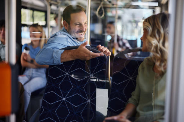 istock Happy man talking to female passenger in a bus. 1759459511