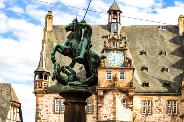 Statue with town hall in Marburg\n\nNote: Fountain with statue was build 1444