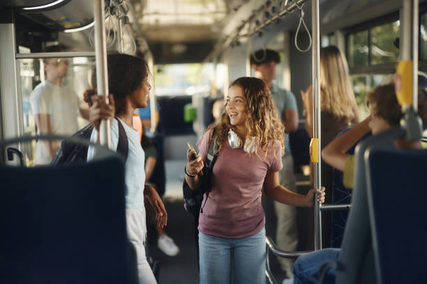 istock Happy students talking while traveling to school in a bus. 1759463382