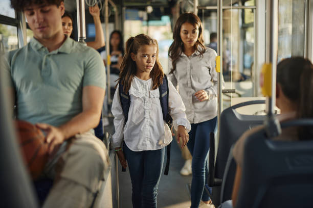 istock Schoolgirl walking through a public transport. 1759466182